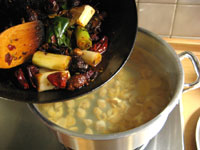 油炒めした薬味を火鍋のスープにうつす